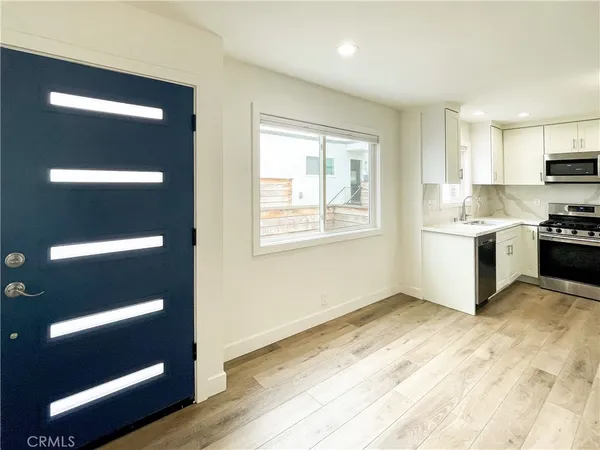 a kitchen with stainless steel appliances a refrigerator sink and microwave