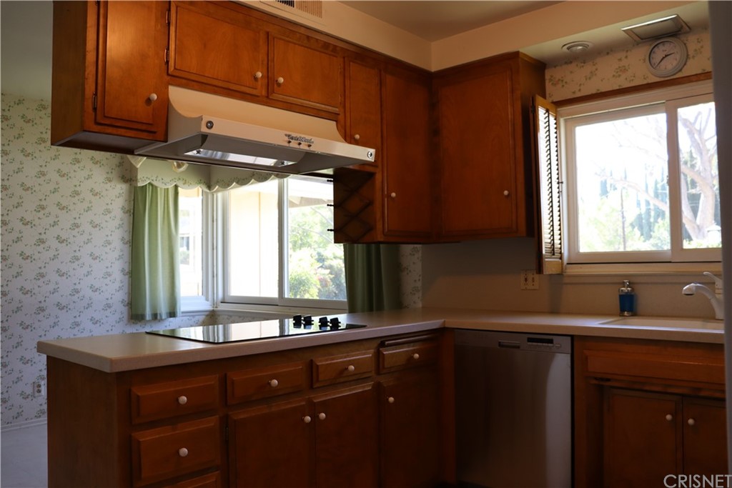 11240 Balcom Avenue Granada Hills, CA 91344 - Photo 11 of 23 a kitchen with a sink window and cabinets