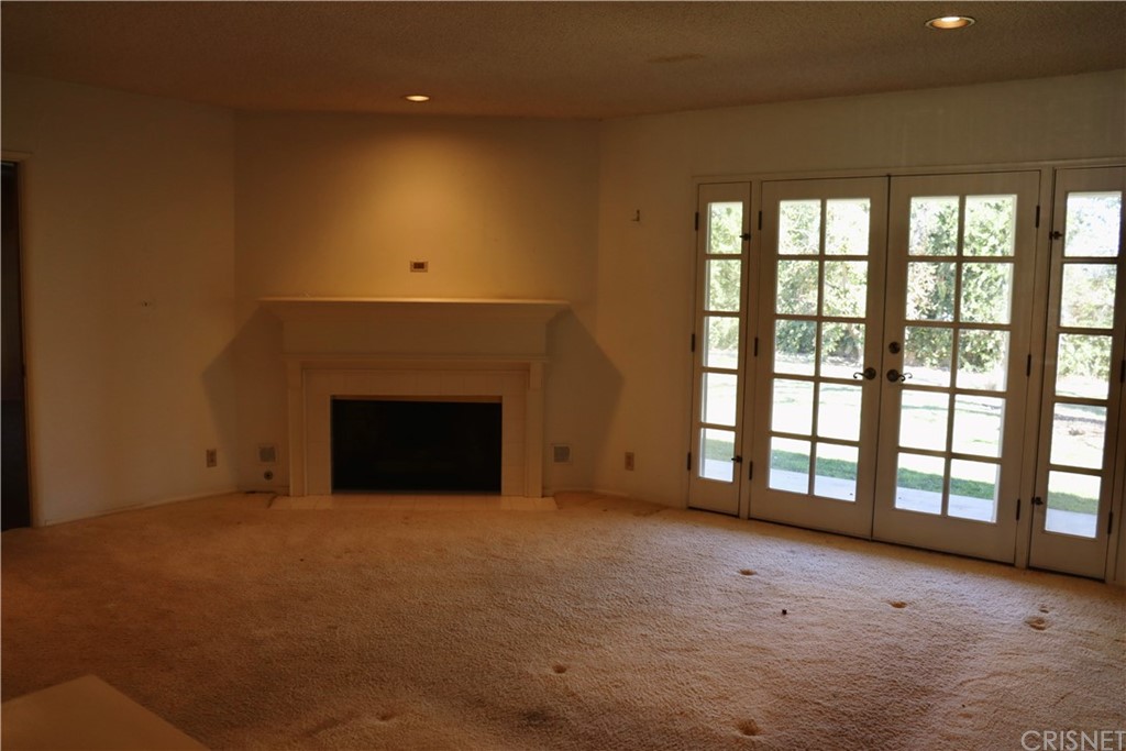11240 Balcom Avenue Granada Hills, CA 91344 - Photo 12 of 23 a view of an empty room with a fireplace