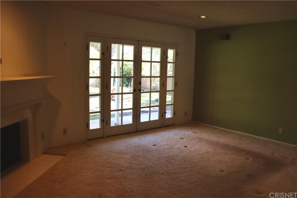 11240 Balcom Avenue Granada Hills, CA 91344 - Photo 13 of 23 an empty room with a fireplace