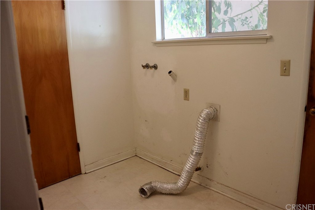 11240 Balcom Avenue Granada Hills, CA 91344 - Photo 14 of 23 a view of a room with rack on the wall
