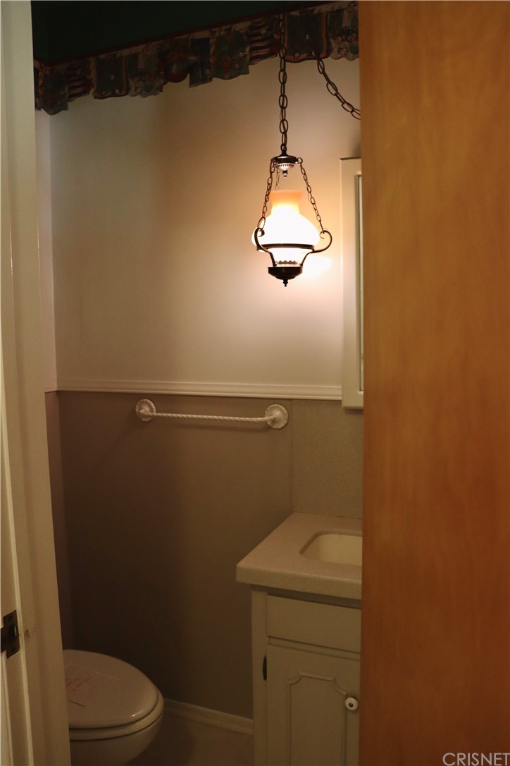 11240 Balcom Avenue Granada Hills, CA 91344 - Photo 15 of 23 a bathroom with a granite countertop toilet and a sink