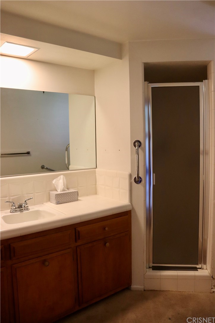 11240 Balcom Avenue Granada Hills, CA 91344 - Photo 20 of 23 a bathroom with a double vanity sink and mirror