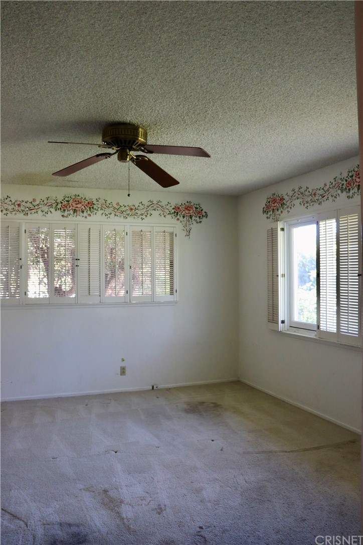 11240 Balcom Avenue Granada Hills, CA 91344 - Photo 21 of 23 an empty room with a ceiling fan and window
