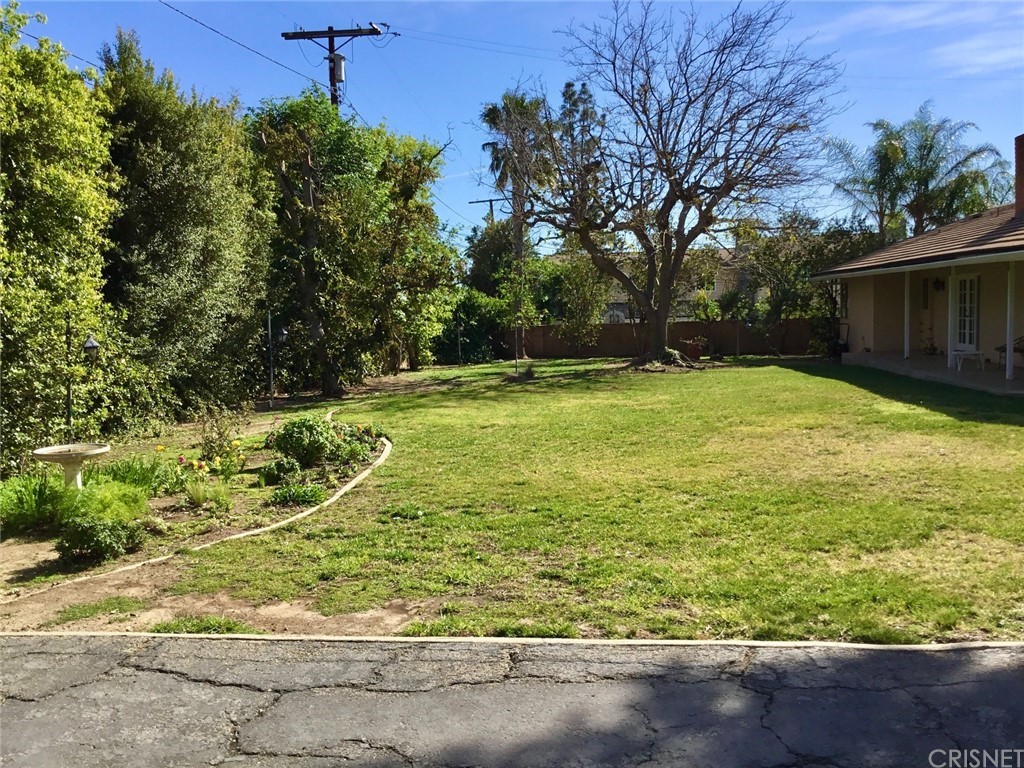 11240 Balcom Avenue Granada Hills, CA 91344 - Photo 7 of 23 a view of a backyard with large trees