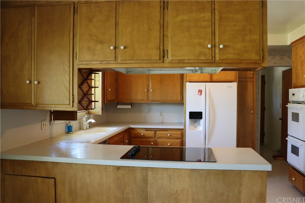 11240 Balcom Avenue Granada Hills, CA 91344 - Photo 10 of 23 a kitchen with a sink and cabinets