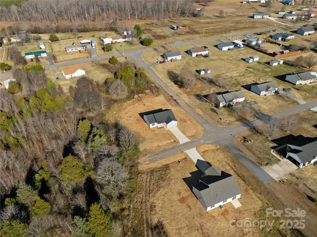 a view of kitchen with kitchen island stainless steel appliances refrigerator stove microwave and cabinets