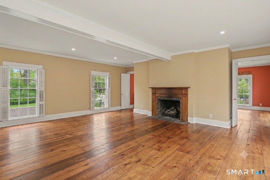 530 Roxbury Road Stamford, CT 06902 - Photo 18 of 40 Spacious & gracious, this welcoming Fammily Room features wood burning fireplace, tons of light and built-in wall of shelving