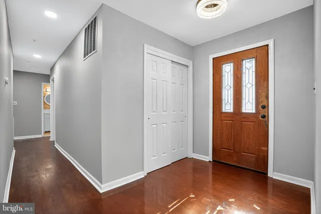 a view of livingroom with front door and wooden floor