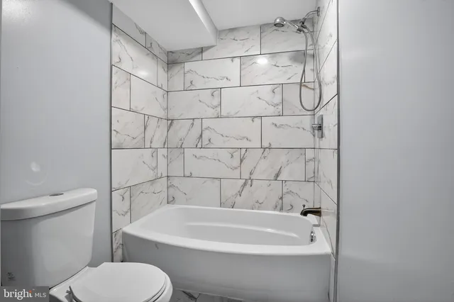 a bathroom with a bathtub and a toilet