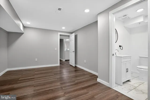 a view of a bathroom with wooden floor and a toilet