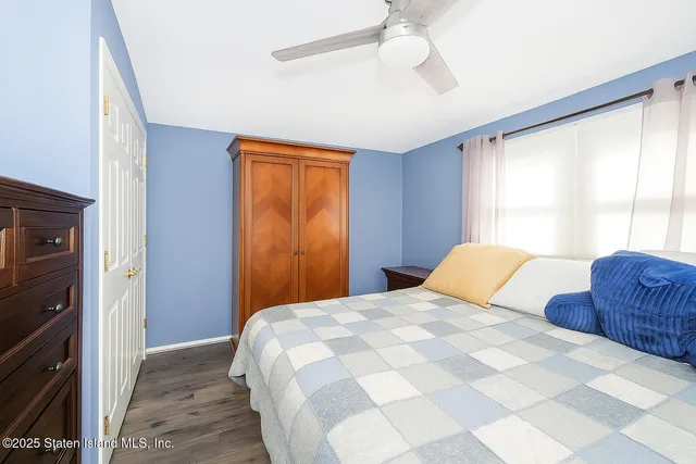 a bedroom with a bed dresser and a window