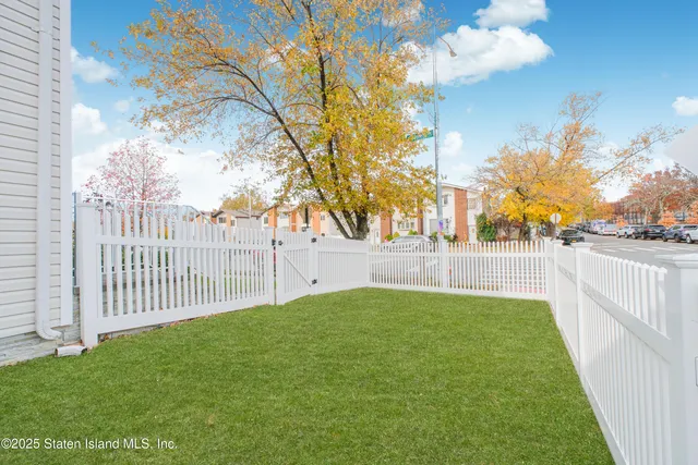 a view of yard with swimming pool and trees