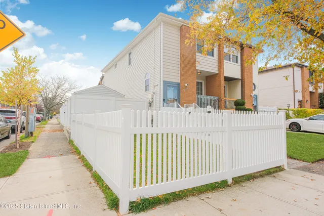 a view of a brick house with large windows