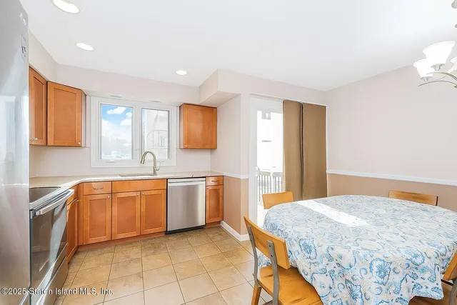 a spacious bathroom with a granite countertop sink mirror and a bathtub