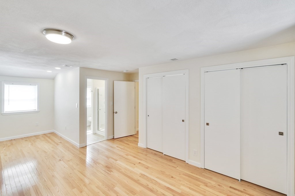 129 Watervale Road, Unit 129 Medford, MA 02155 - Photo 13 of 29 a view of an empty room and wooden floor