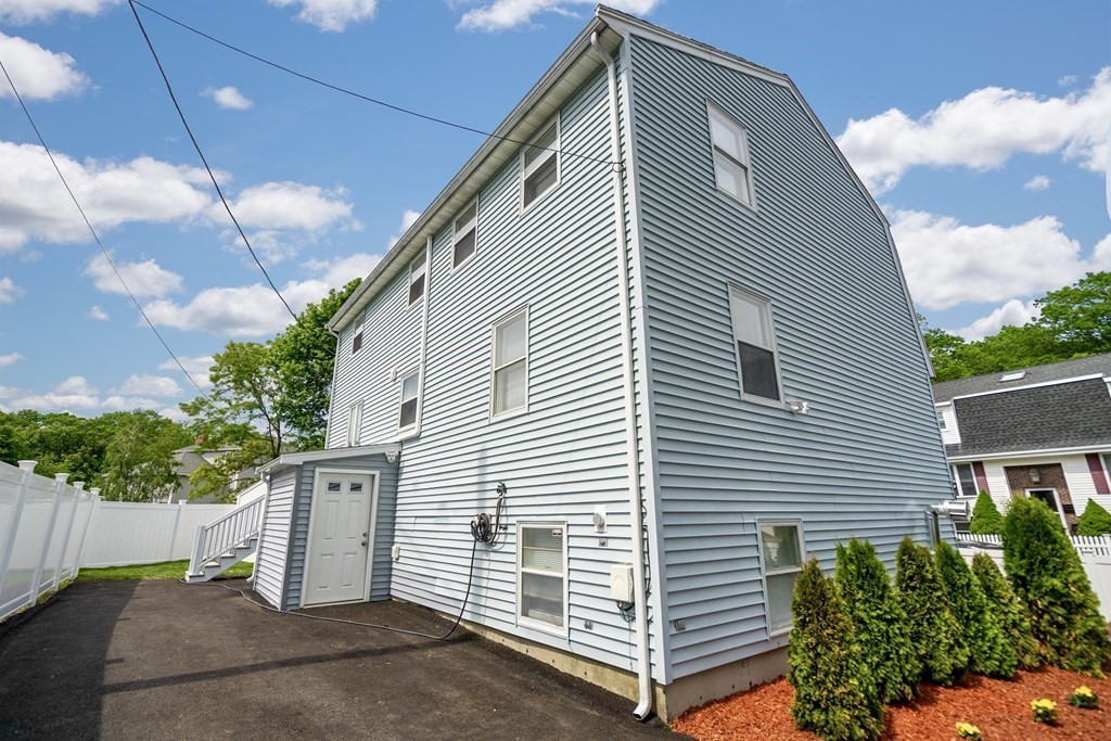 129 Watervale Road, Unit 129 Medford, MA 02155 - Photo 28 of 29 a side view of a house with a garage