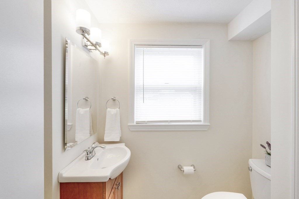 129 Watervale Road, Unit 129 Medford, MA 02155 - Photo 8 of 29 a bathroom with a sink a toilet and a mirror