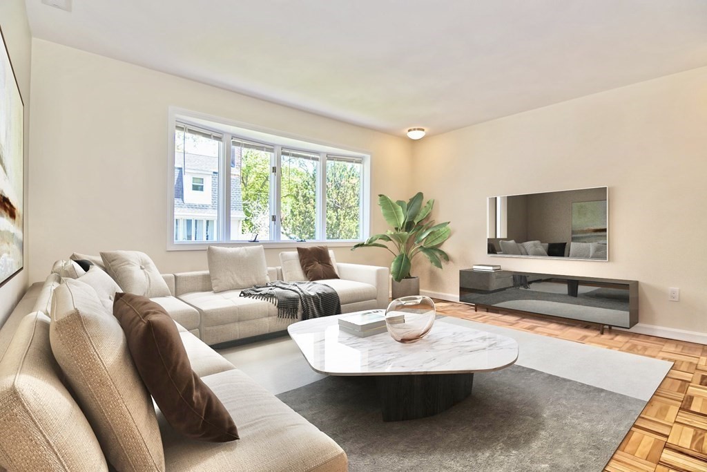 129 Watervale Road, Unit 129 Medford, MA 02155 - Photo 9 of 29 a living room with furniture and a flat screen tv