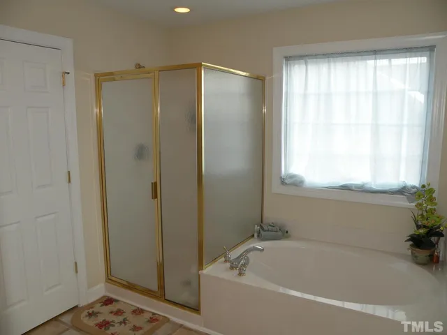 a bathroom with a bathtub and shower