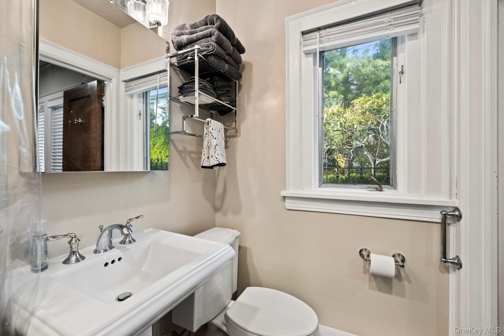 44 Fenimore Road New Rochelle, NY 10804 - Photo 16 of 46 a bathroom with a sink a toilet and mirror