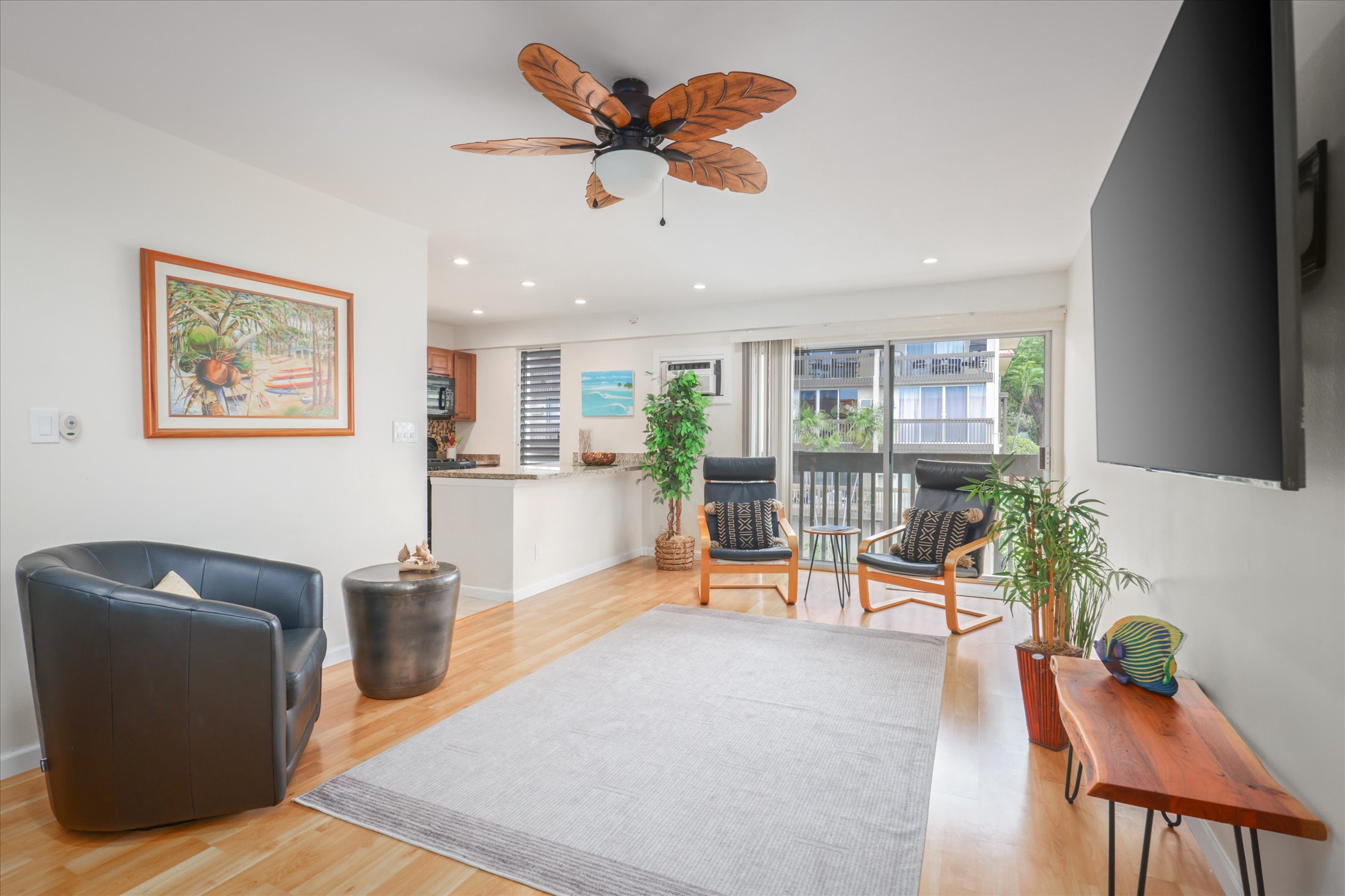 75-5873 Walua Road, Unit 312 Kailua-Kona, HI 96740 - Photo 1 of 15 a view of a livingroom with furniture and a potted plant