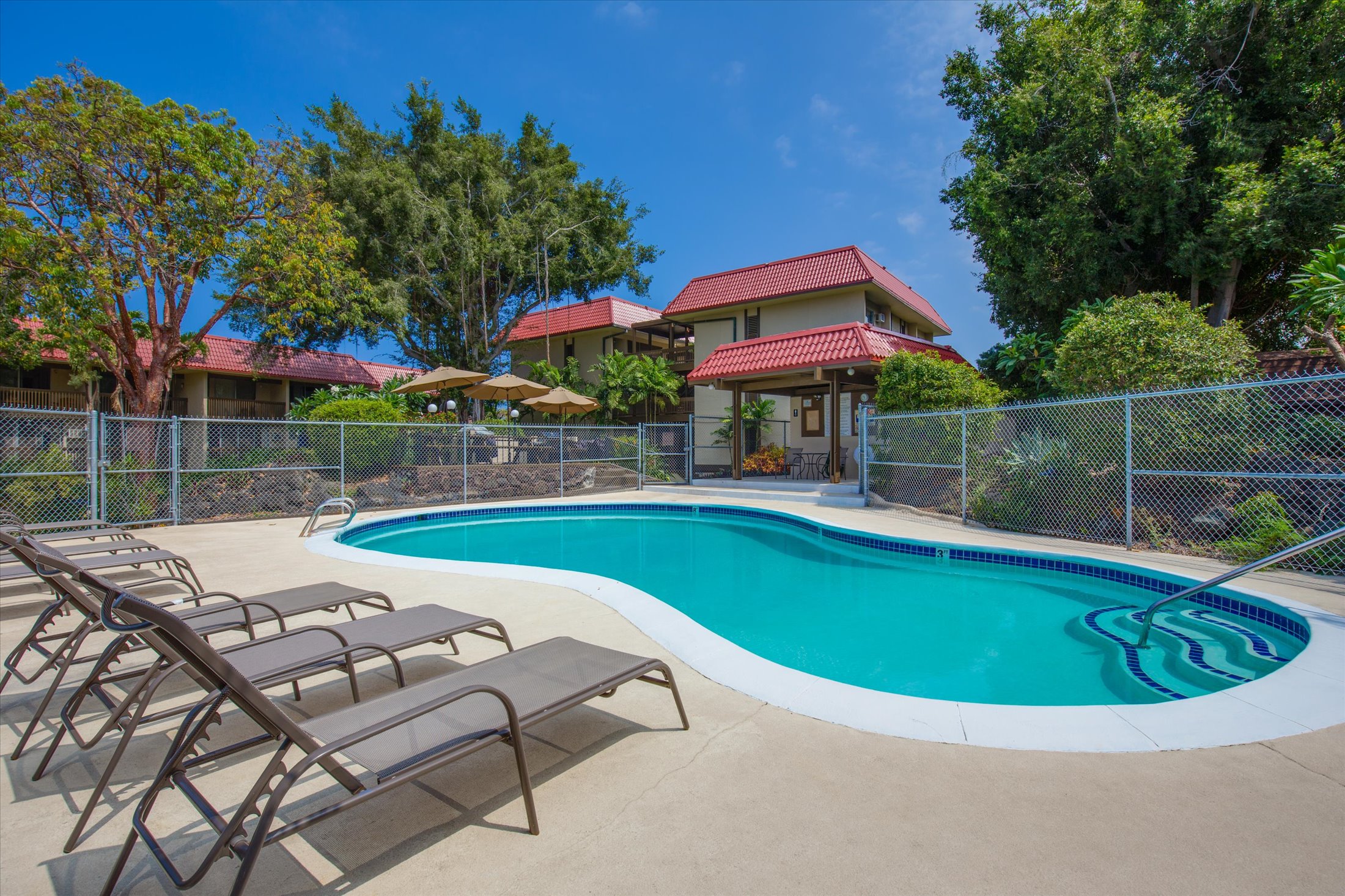 75-5873 Walua Road, Unit 312 Kailua-Kona, HI 96740 - Photo 11 of 15 a view of a swimming pool with a patio