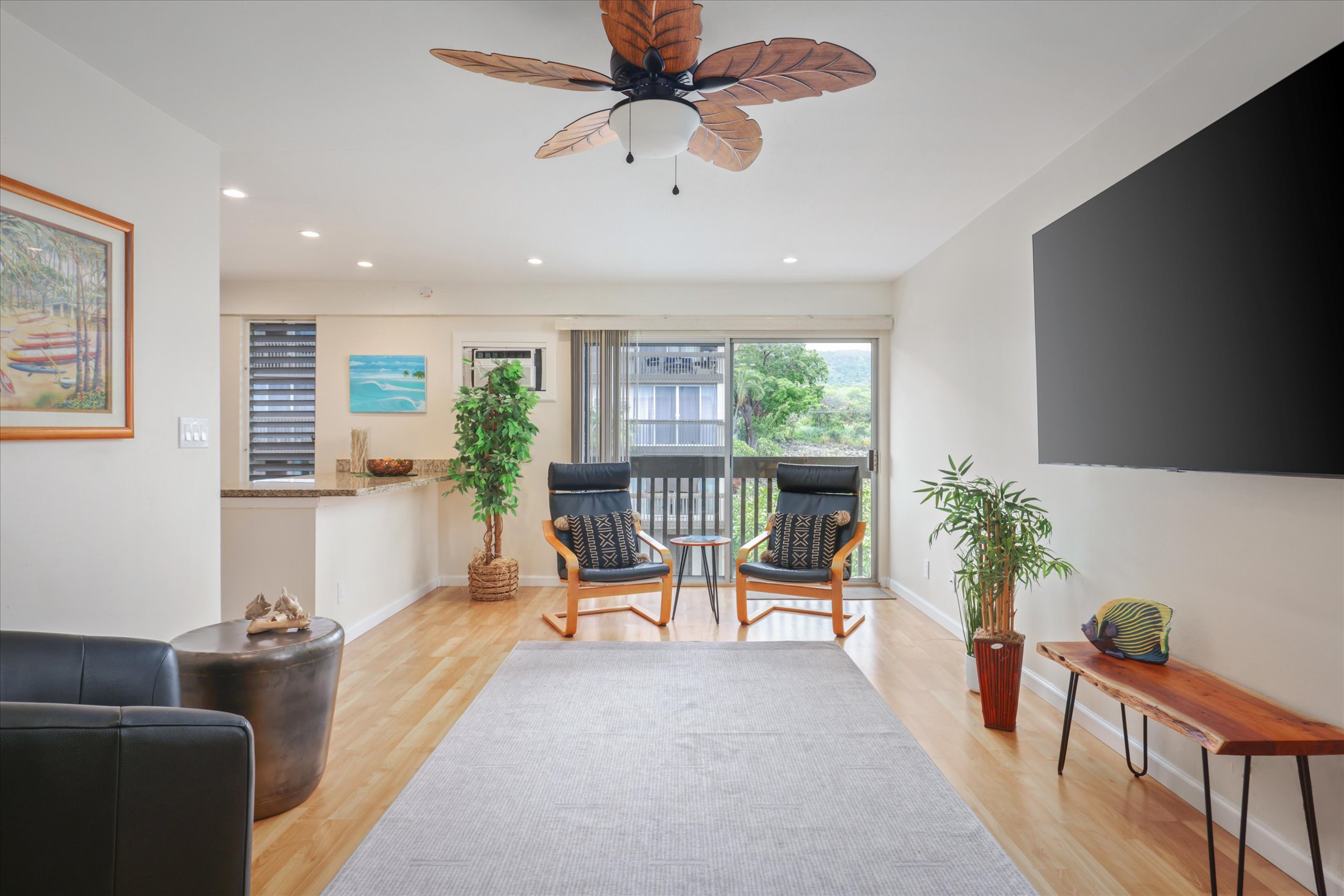 75-5873 Walua Road, Unit 312 Kailua-Kona, HI 96740 - Photo 3 of 15 a living room with furniture and a potted plant