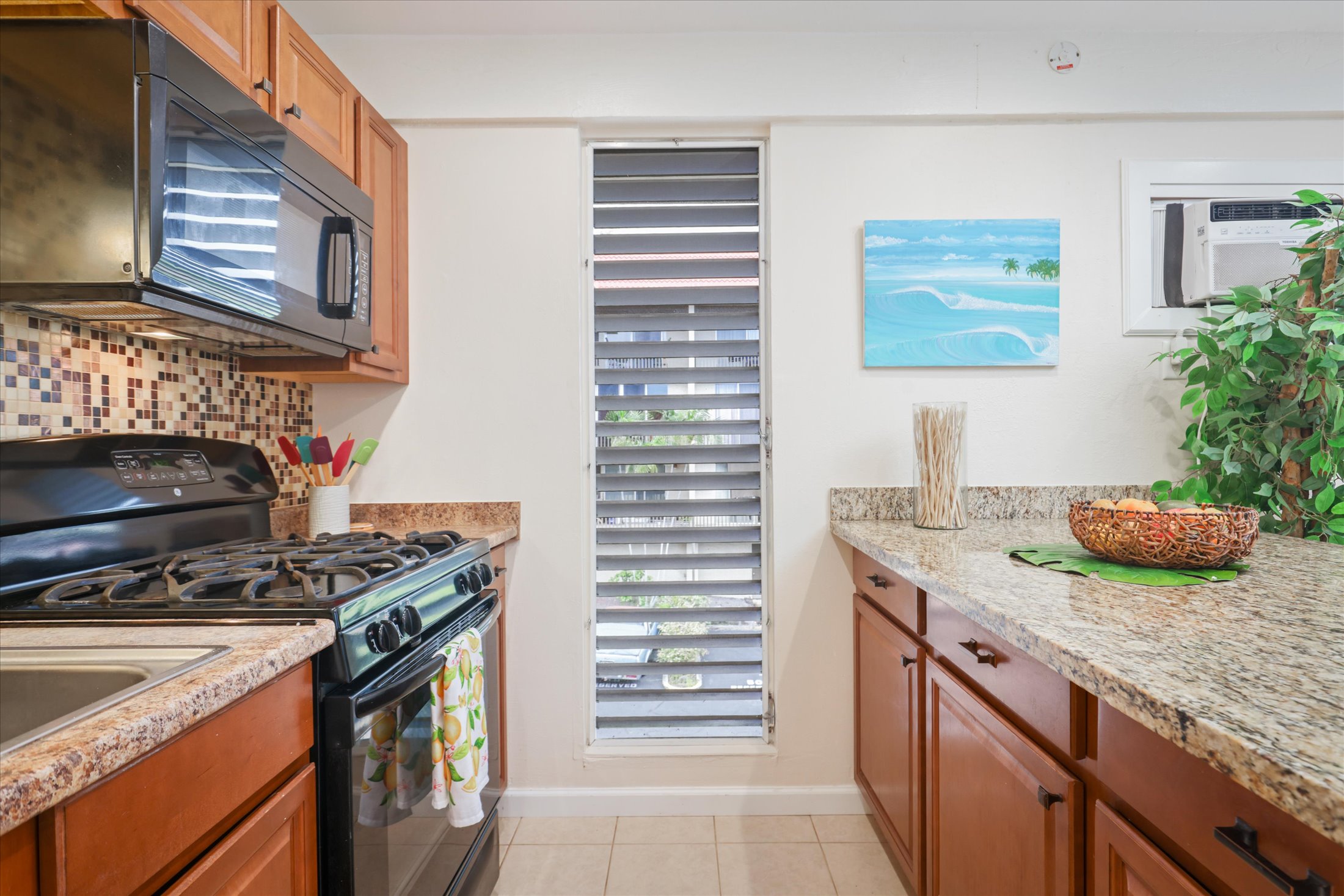 75-5873 Walua Road, Unit 312 Kailua-Kona, HI 96740 - Photo 5 of 15 a kitchen with stainless steel appliances granite countertop a stove and a sink