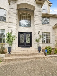 a house with a potted plant on side of it