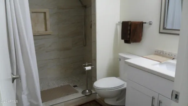 a white toilet sitting next to a bathroom sink