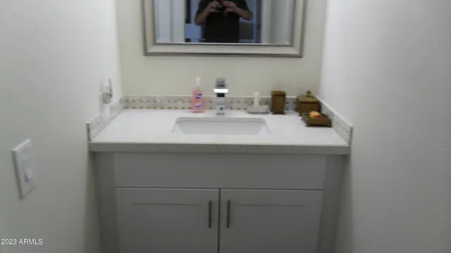 a bathroom with a sink and a mirror