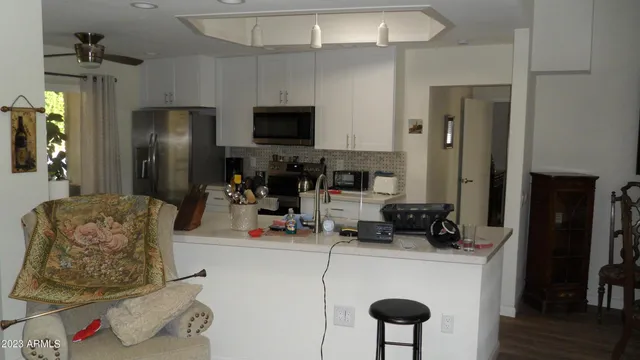 a room with furniture a flat screen tv and a window