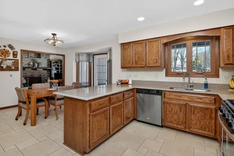 a kitchen with a stove sink and cabinets