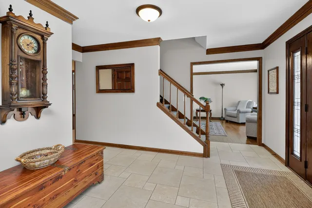 a living room with furniture and a wall painting