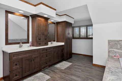 a spacious bathroom with a double vanity sink and a mirror