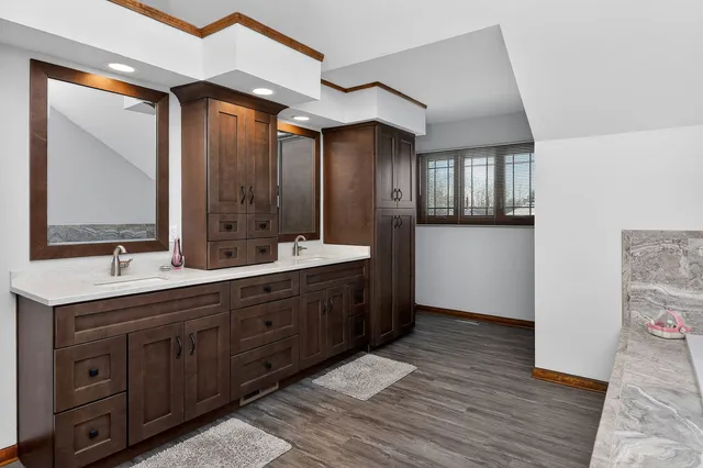 a spacious bathroom with a double vanity sink and a mirror