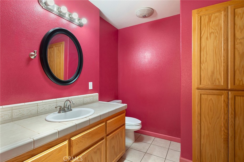 4940 Papya Road Forest Ranch, CA 95942 - Photo 13 of 67 a bathroom with a sink a mirror and a toilet