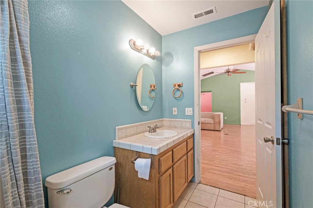 4940 Papya Road Forest Ranch, CA 95942 - Photo 17 of 67 a bathroom with a toilet sink vanity and mirror