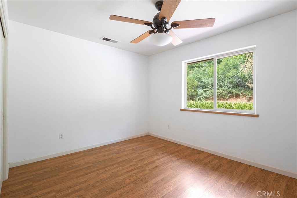 4940 Papya Road Forest Ranch, CA 95942 - Photo 18 of 67 an empty room with a window and a fan