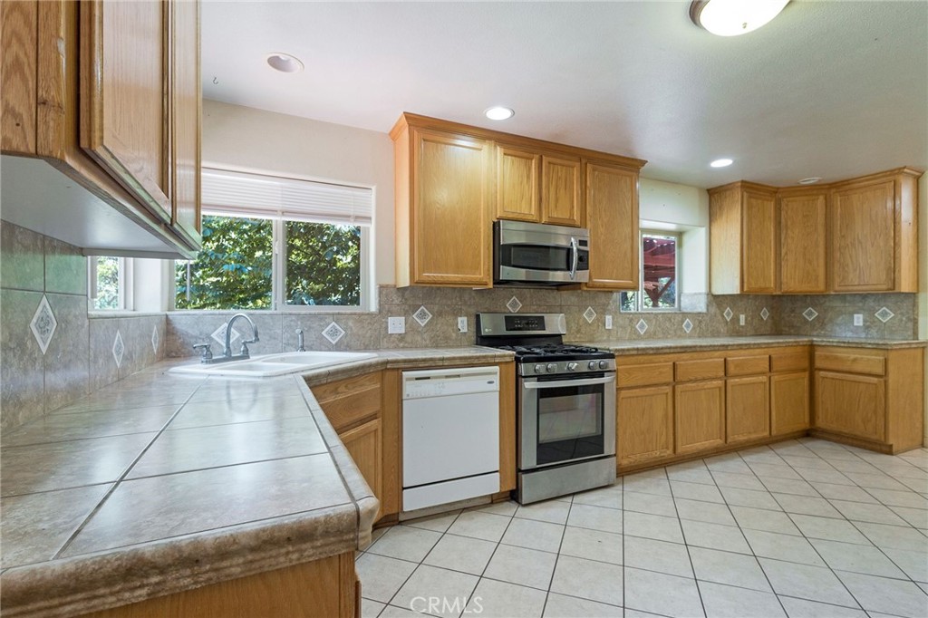 4940 Papya Road Forest Ranch, CA 95942 - Photo 22 of 67 a kitchen with a sink a stove top oven and cabinets