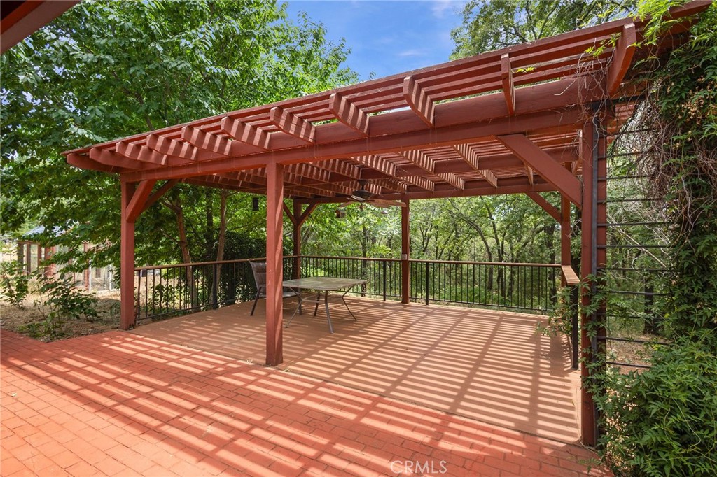 4940 Papya Road Forest Ranch, CA 95942 - Photo 38 of 67 a view of a backyard with a large tree and wooden fence