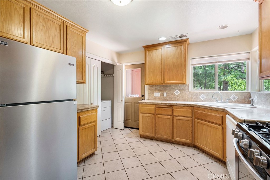 4940 Papya Road Forest Ranch, CA 95942 - Photo 7 of 67 a kitchen with stainless steel appliances a refrigerator sink and cabinets