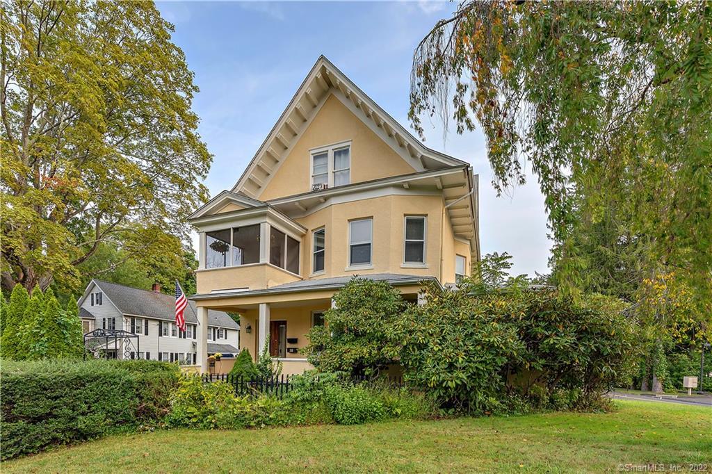 32 Gilbert Street Ridgefield, CT 06877 - Photo 1 of 1 a view of a white house next to a yard with big trees