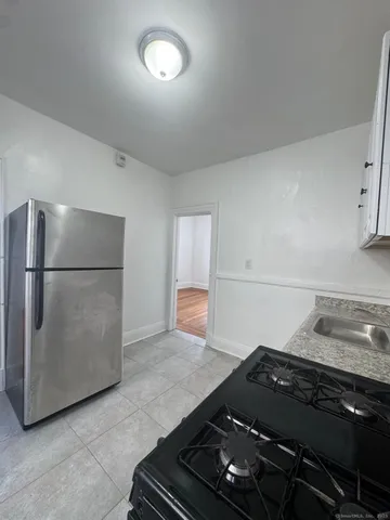 a stove top oven sitting inside of a kitchen