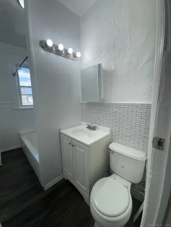 a white toilet sitting next to a bathroom sink