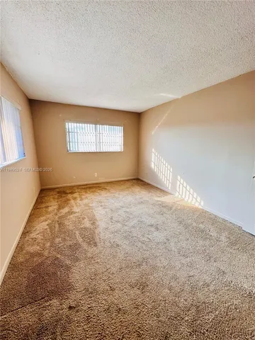 a view of an empty room and a window