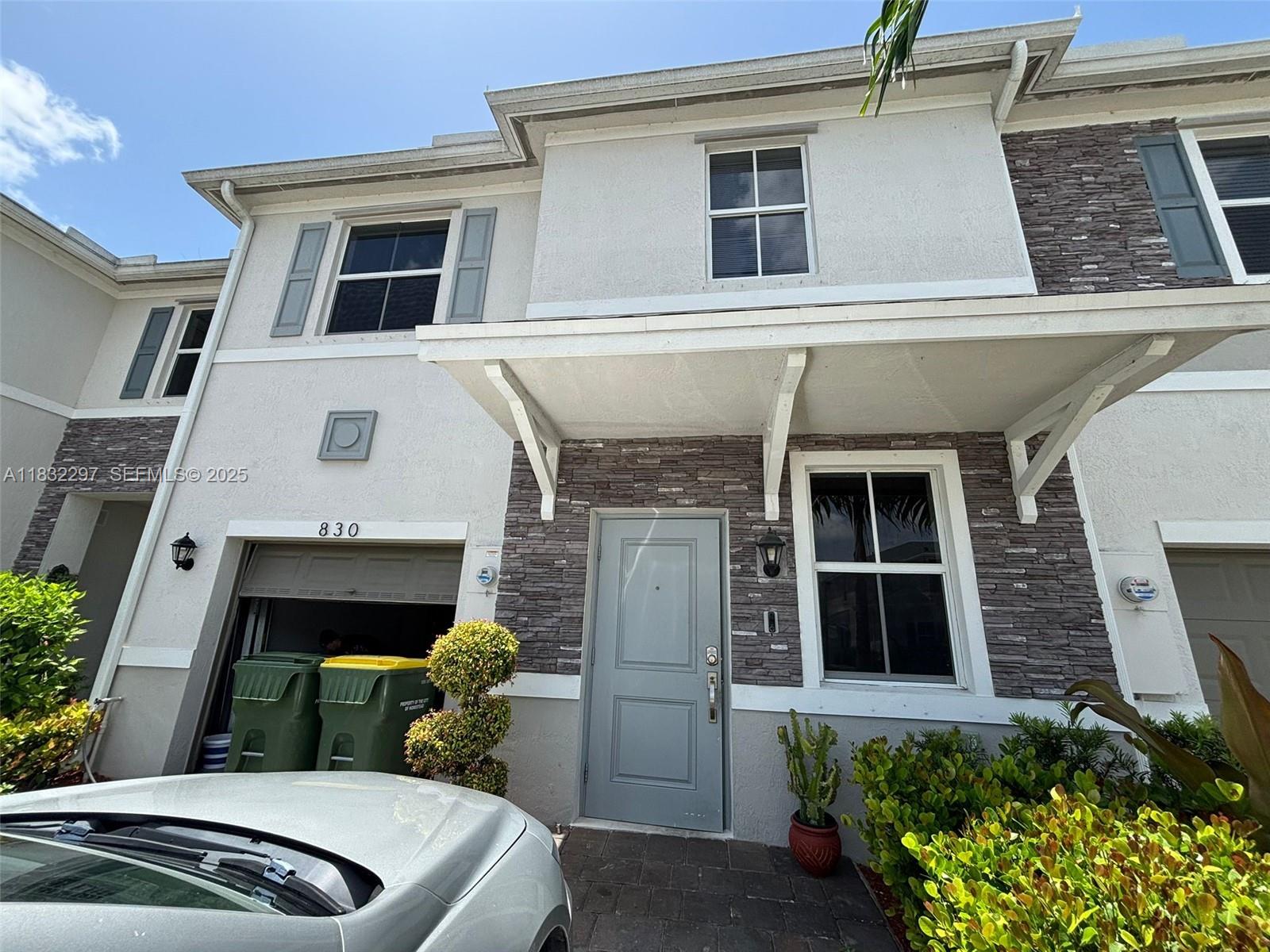 830 Southeast 19th Street Homestead, FL 33034 - Photo 1 of 16 a front view of a house with a yard