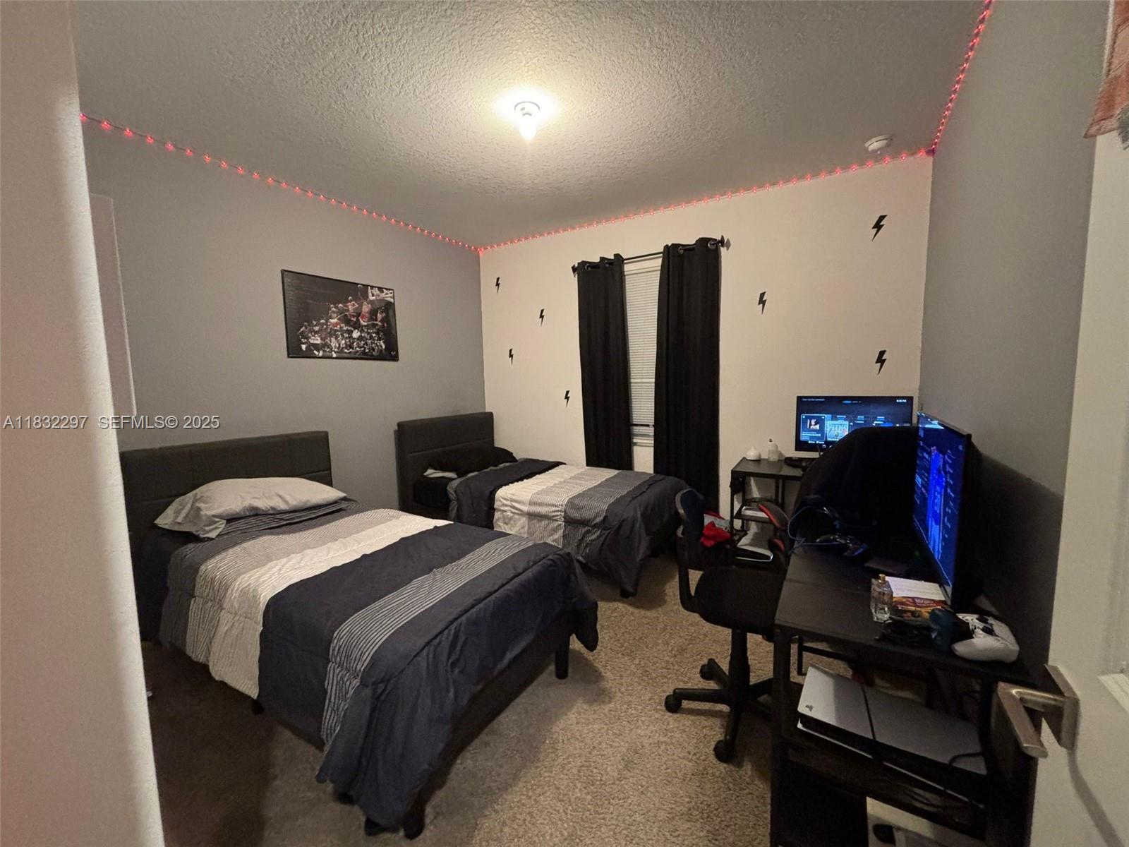 830 Southeast 19th Street Homestead, FL 33034 - Photo 11 of 16 a bedroom with a bed and a chair