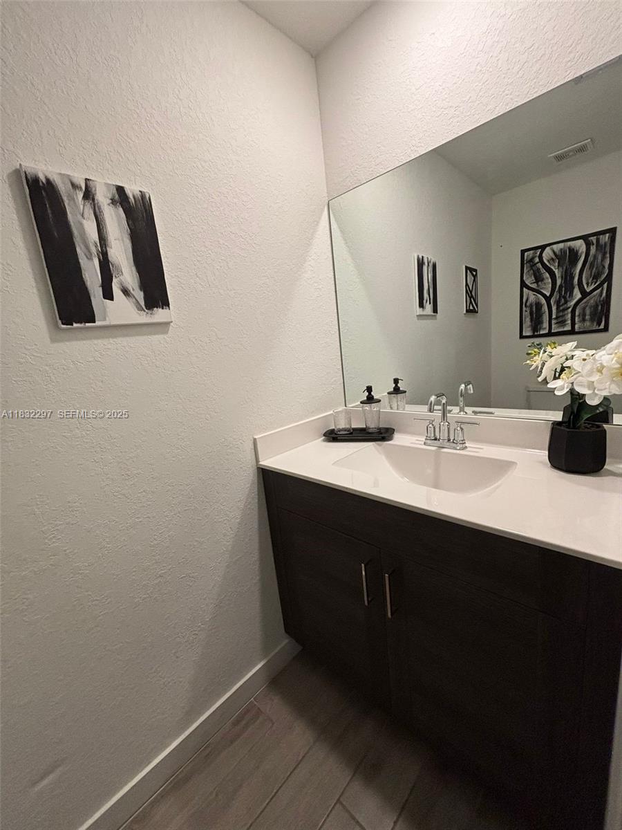 830 Southeast 19th Street Homestead, FL 33034 - Photo 13 of 16 a bathroom with a sink and a mirror